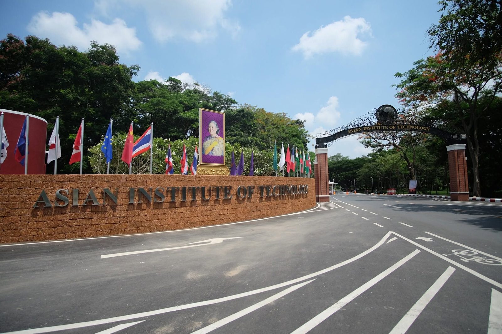 The campus entrance, with flags and the name Asian Institute of Technology on the gate